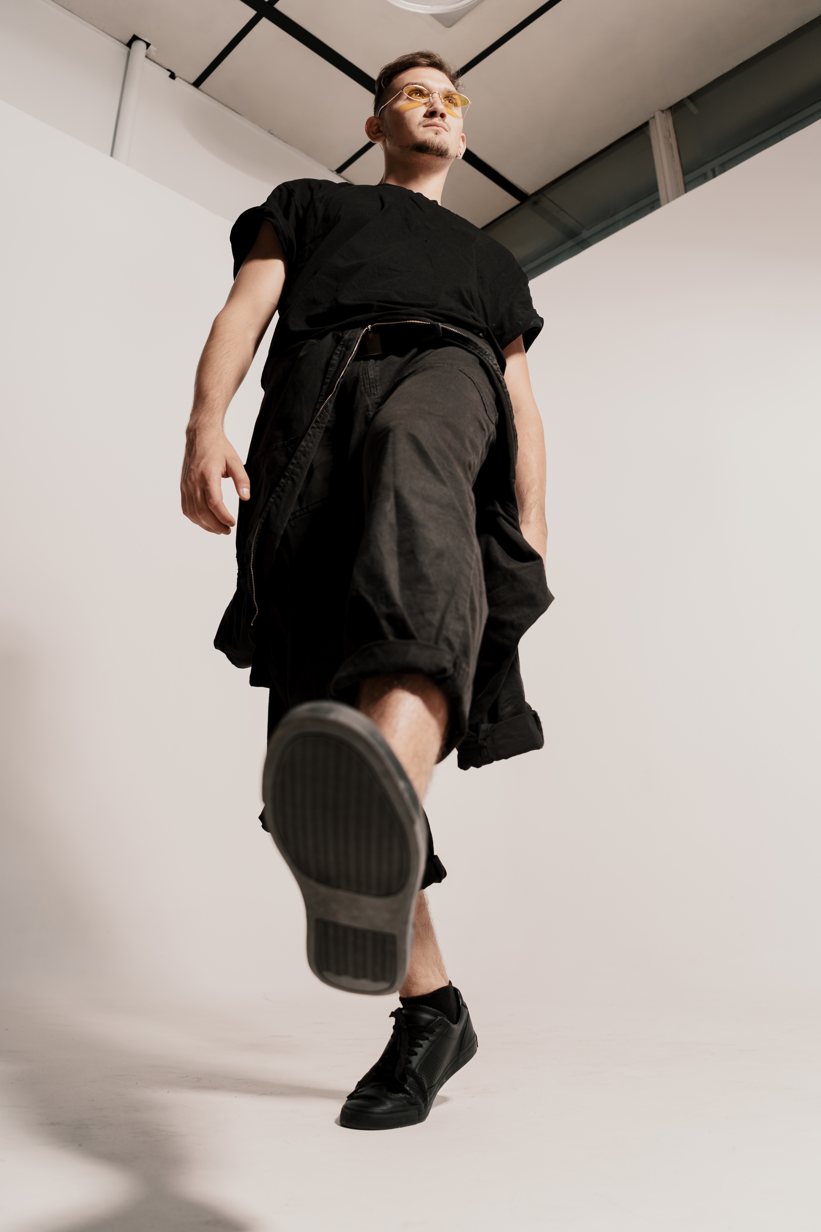 CONFIDENT_MAN_JUMPING_WALKING_AGAINST_WHITE